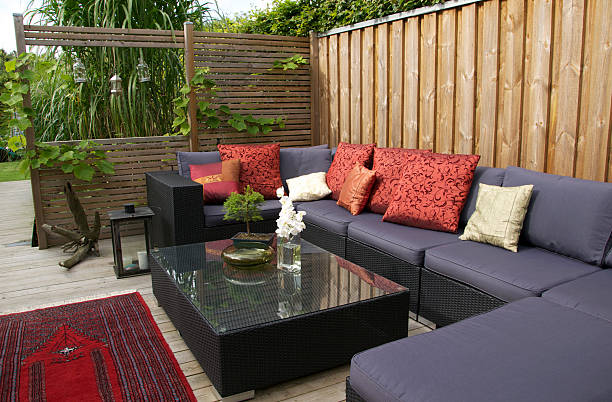 A Patio With An Outdoor Wicker Sofa.